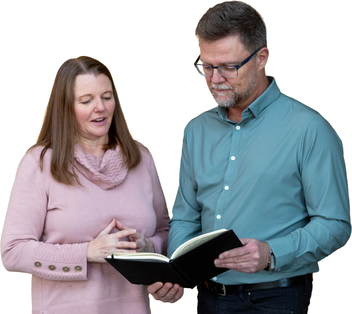 A man and woman reading a book together.