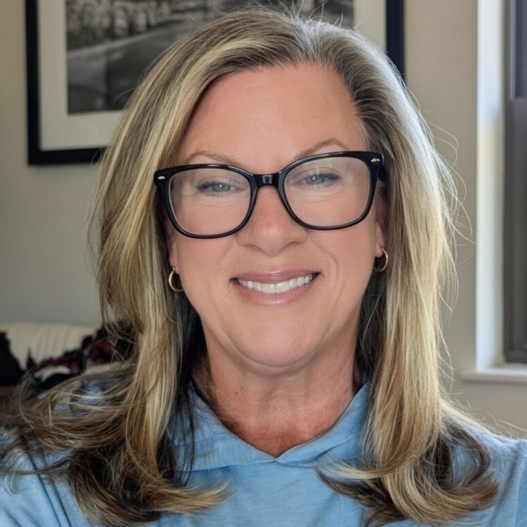 Smiling woman with glasses and blonde hair